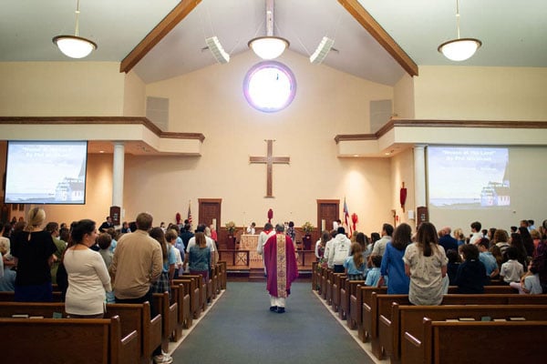 The inside of the chapel with a church session in progress.