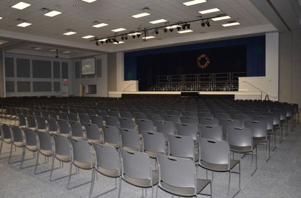 The theater area in the hall with a stage and many rows of seats.